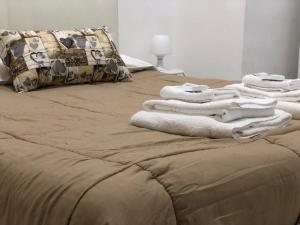a pile of towels sitting on top of a bed at Al Porto in Gaeta