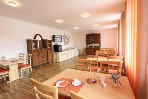 a dining room with wooden tables and chairs at Pension Leonardo in Aidenbach
