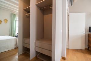 a bedroom with a walk in closet and a bed at Appartamento Delle Vele in Venice
