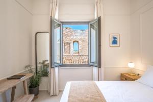 a bedroom with a bed and an open window at Casa Dei Miracoli in Chania Town