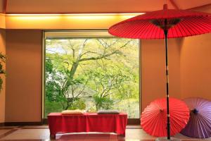 
a red umbrella sitting on top of a white table at Yutorelo-an in Hakone
