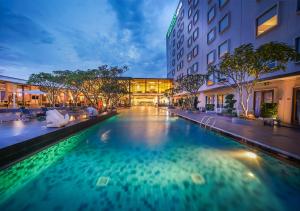 a swimming pool in the middle of a building at HARRIS Hotel Sentul City Bogor in Bogor