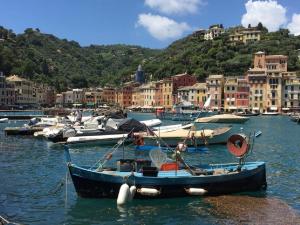 a group of boats docked in a harbor with buildings at House Orizzonte - Casa Bianca in Genoa