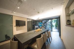 a dining room with a black table and chairs at Timing House in Yuchi