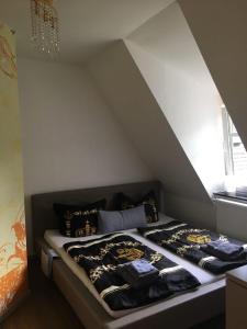 a bedroom with two beds in a attic at Ferienwohnung Villa am Schloßberg in Bad Berka
