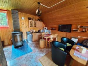 a living room with a kitchen and a dining room at Chata Talia in Liptovský Mikuláš