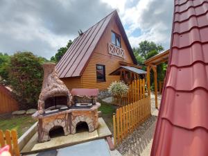 a small house with a play structure in front of it at Chata Talia in Liptovský Mikuláš