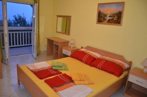 a bedroom with a bed with two pillows on it at Villa nad Morem in Podaca