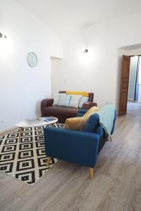 a living room with a couch and a table at Appartement Gaudin in Bastia