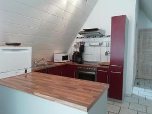 a kitchen with a wooden counter top in a room at Ferienwohnung Familie Faath in Bellheim