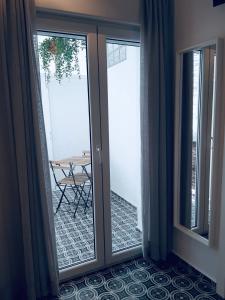 a sliding glass door with a table on a patio at Room Boutique 32 in Denia