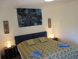 a bedroom with a bed with blue pillows on it at LA GRANGE in Saint-Prix-lès-Arnay