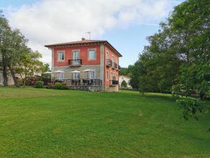 a large house with a green lawn in front of it at Apartamentos Santa Marina in Llanes