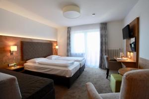 Postel nebo postele na pokoji v ubytování Hotel-Restaurant am Hochfuchs