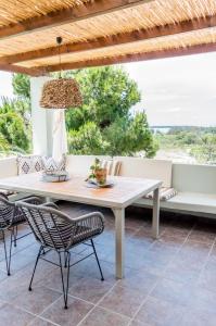 a white table and chairs on a patio at Pernakria in Skala Rachoniou