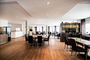 a restaurant with wooden floors and tables and chairs at Sternplatz-Hotel in Ehingen