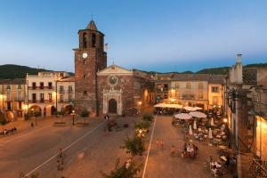 an old building with a clock tower in a town at Cal Tomaset in Prades