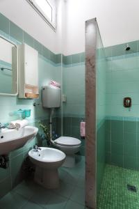 a bathroom with two toilets and a sink at Hotel Bella Zurigo in Cesenatico