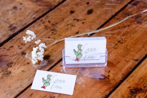 two cards sitting on a wooden floor with flowers at Casa Fina in Santiago del Teide