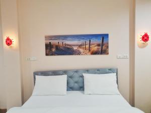 Postel nebo postele na pokoji v ubytování โรงแรมประทับใจ