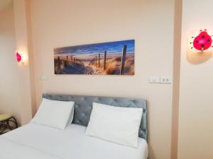 Postel nebo postele na pokoji v ubytování โรงแรมประทับใจ