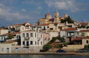a group of houses on a hill next to the water at La Casetta in Galaxidi
