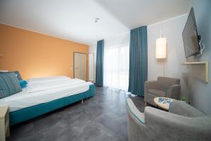 Ein Bett oder Betten in einem Zimmer der Unterkunft Riff Resort
