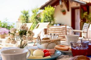 a table with plates of food and flowers on it at Antica Stazione in Taormina +10 photos