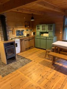 a large kitchen with a stove and a table at DOMY na GÓRCE in Narty +19 photos