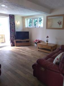 a living room with a couch and a table at Rosedene in Mablethorpe