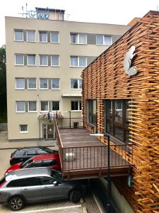 a building with a deck next to a parking lot at Hotel Bobr in Chomutov