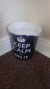 a black and white trash can with a white lid at The Victoria guest house in Mablethorpe