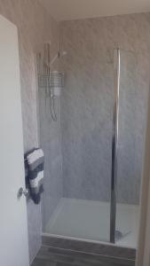 a shower with a glass door in a bathroom at The Victoria guest house in Mablethorpe