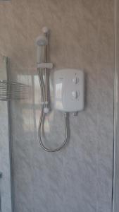 a shower in a bathroom with a blow dryer at The Victoria guest house in Mablethorpe