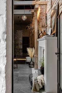 a room with a hallway with a brick wall at Mystictone - loft in the heart of Warsaw - Nowy Świat ROOMTONES in Warsaw