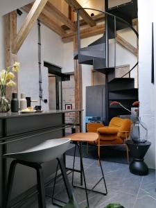a living room with a table and chairs at Mystictone - loft in the heart of Warsaw - Nowy Świat ROOMTONES in Warsaw
