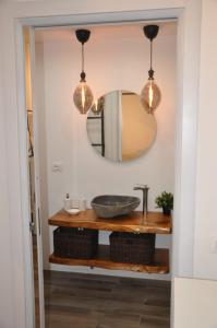 a bathroom with a sink and a mirror at C'era una volta Appartamento OPEN SPACE Sestri Levante in Sestri Levante