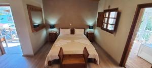 A bed or beds in a room at Akrotiri B&B