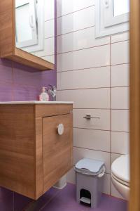 a bathroom with a toilet and a sink at Oneiric Harmony in Mikri Vigla