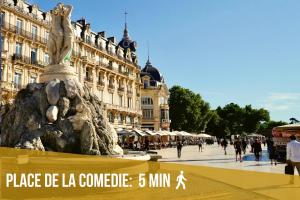 a statue in the middle of a street with a building at Le Saint Roch-Centre-Free Parking-Clim in Montpellier