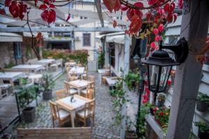 an outdoor patio with tables and chairs and flowers at Huge Stylish Apartment Monroe 1 / City Centre in Plovdiv