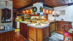 a large kitchen with wooden cabinets and a center island at Hotel-Gasthof Zum Freigericht in Alzenau in Unterfranken