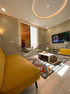 a living room with a couch and a tv at A - 369 مقابل الراشد مول in Abha