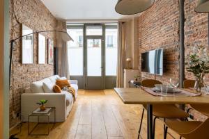 a living room with a brick wall at Boutik Boheme Le Loft Batignolles in Paris