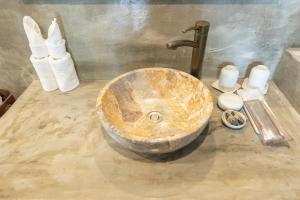 a bathroom with a stone sink in a room at Victory Road Villas in Phong Nha