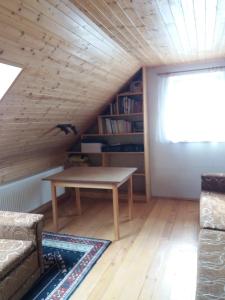 a living room with a table in the attic at U tří jasanů in Luže