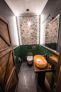a bathroom with a wooden sink and a toilet at Murat Pasha Mansion in Dalyan