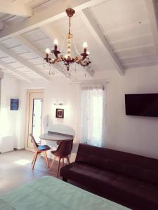 a living room with a couch and a chandelier at Villa Anna in Nafpaktos
