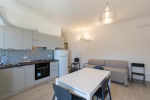 a kitchen and living room with a table and a table and chairs at Residenza Las Vegas in Bellaria-Igea Marina