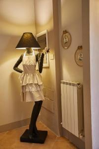 a statue of a woman in a dress holding a lamp at Vecchio Granaio in Pisa